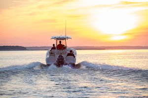 Grady-White Fisherman 216 21-foot center console boat running sunset stern
