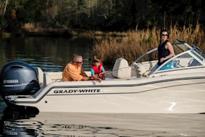Grady-White Freedom 215 21-foot dual console kid reeling in fish