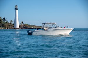 Grady-White Freedom 335 33-foot dual console fishing boat cruising out of inlet