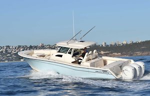 Grady-White Canyon 376 37-foot center console boat running port side city background