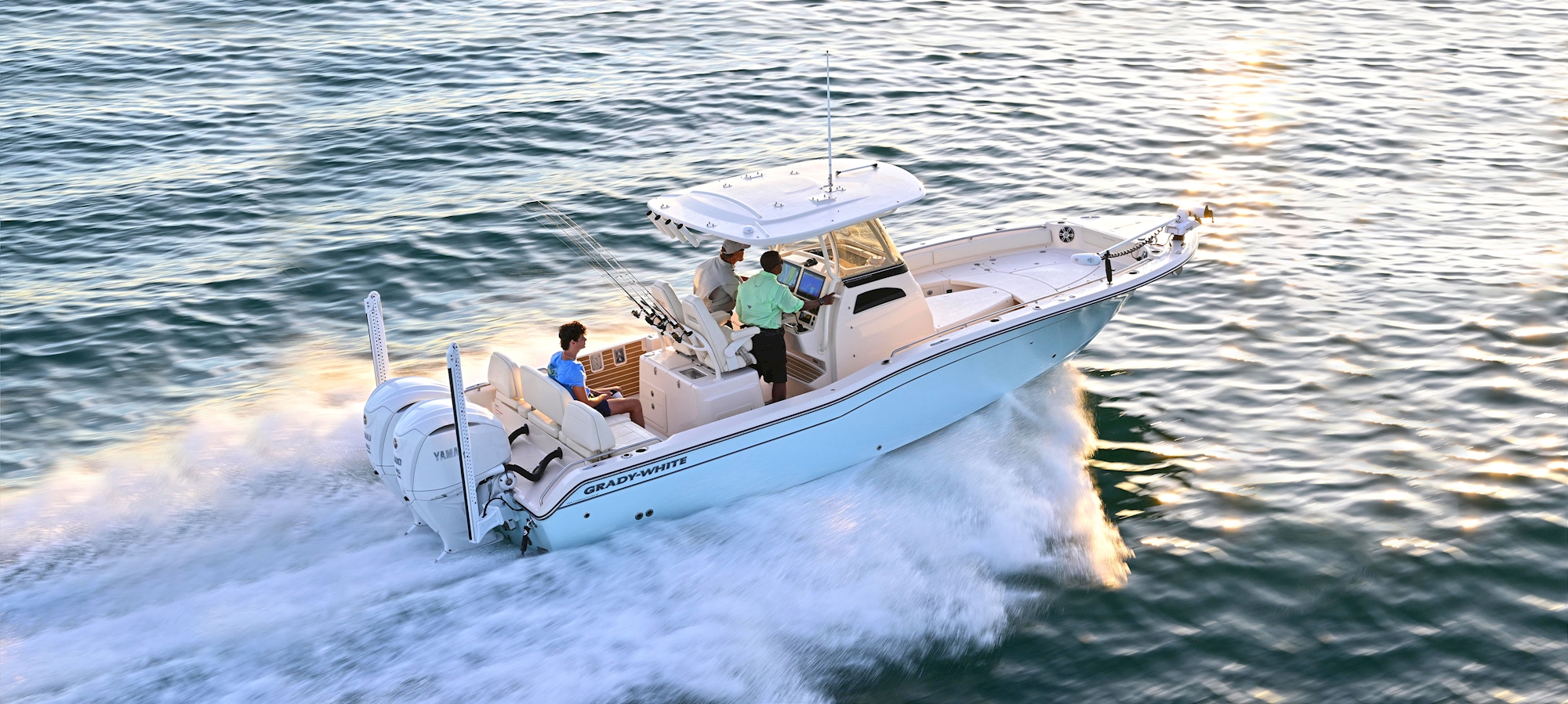 Grady-White 281 CE 28-foot Coastal Explorer boat running on the water with three people aboard
